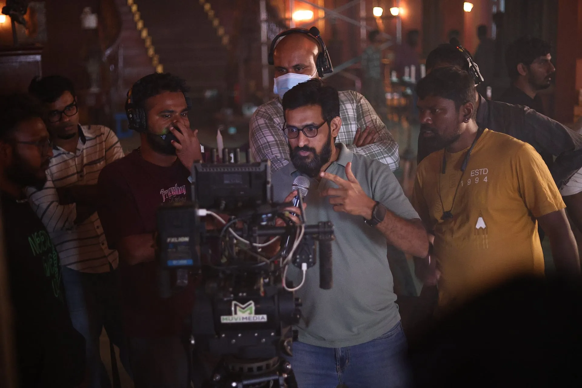 Director Pushpanathan Arumugam at the monitor during the Vanjam Theer shoot