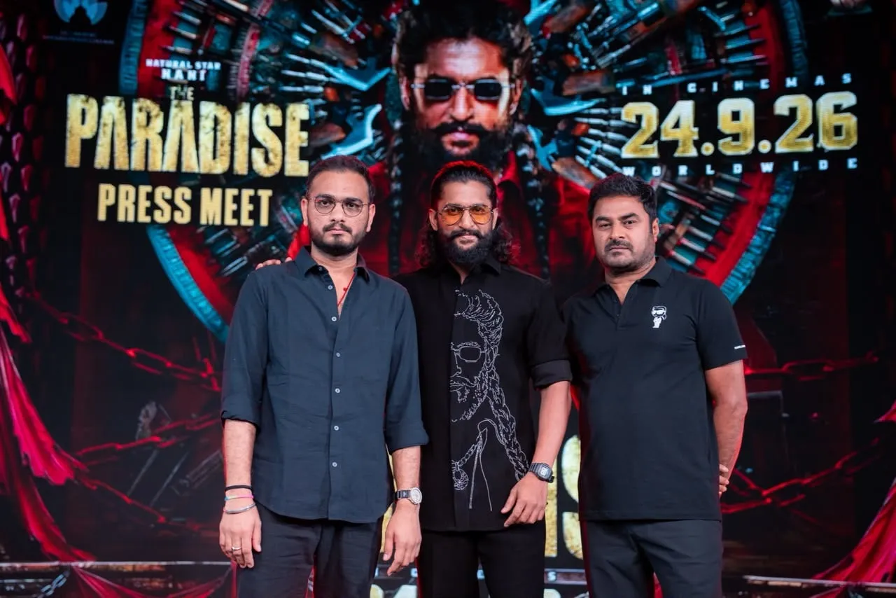 Nani stands with two members of The Paradise team before the film's September 24 release display