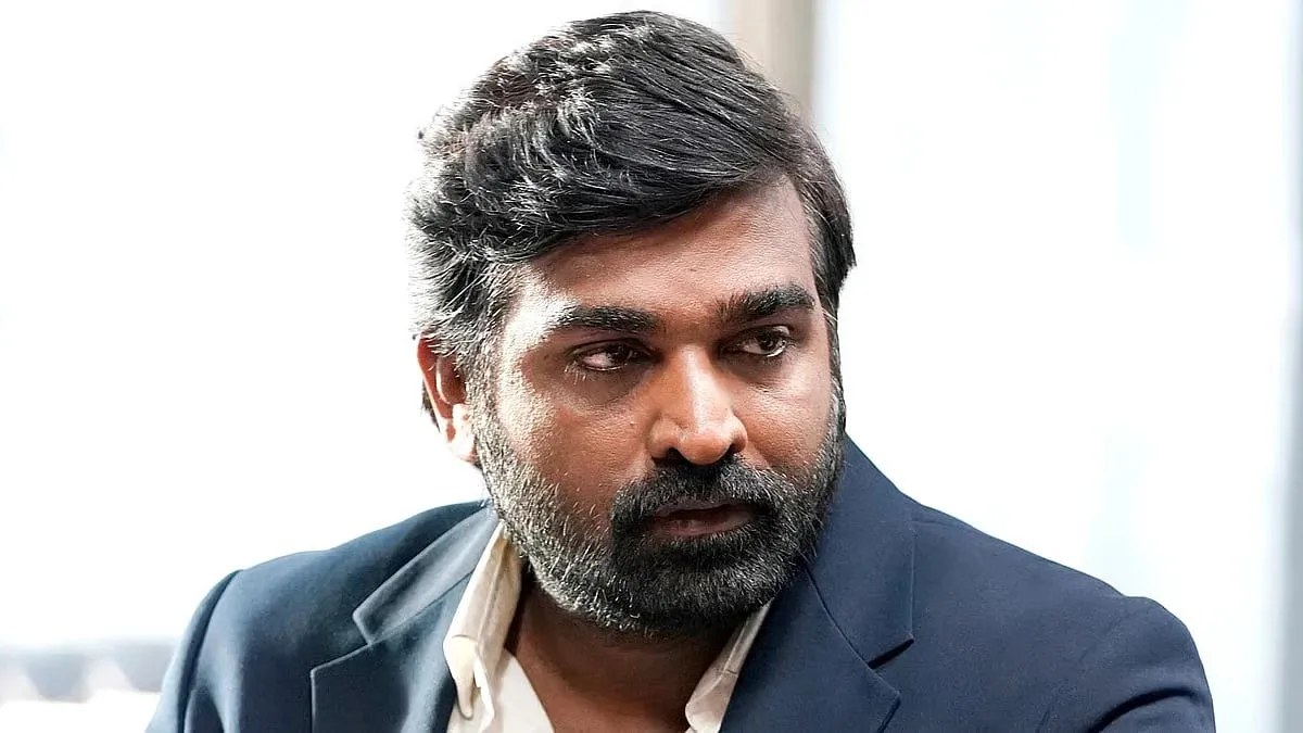 Vijay Sethupathi in a dark blazer, looking away from the camera