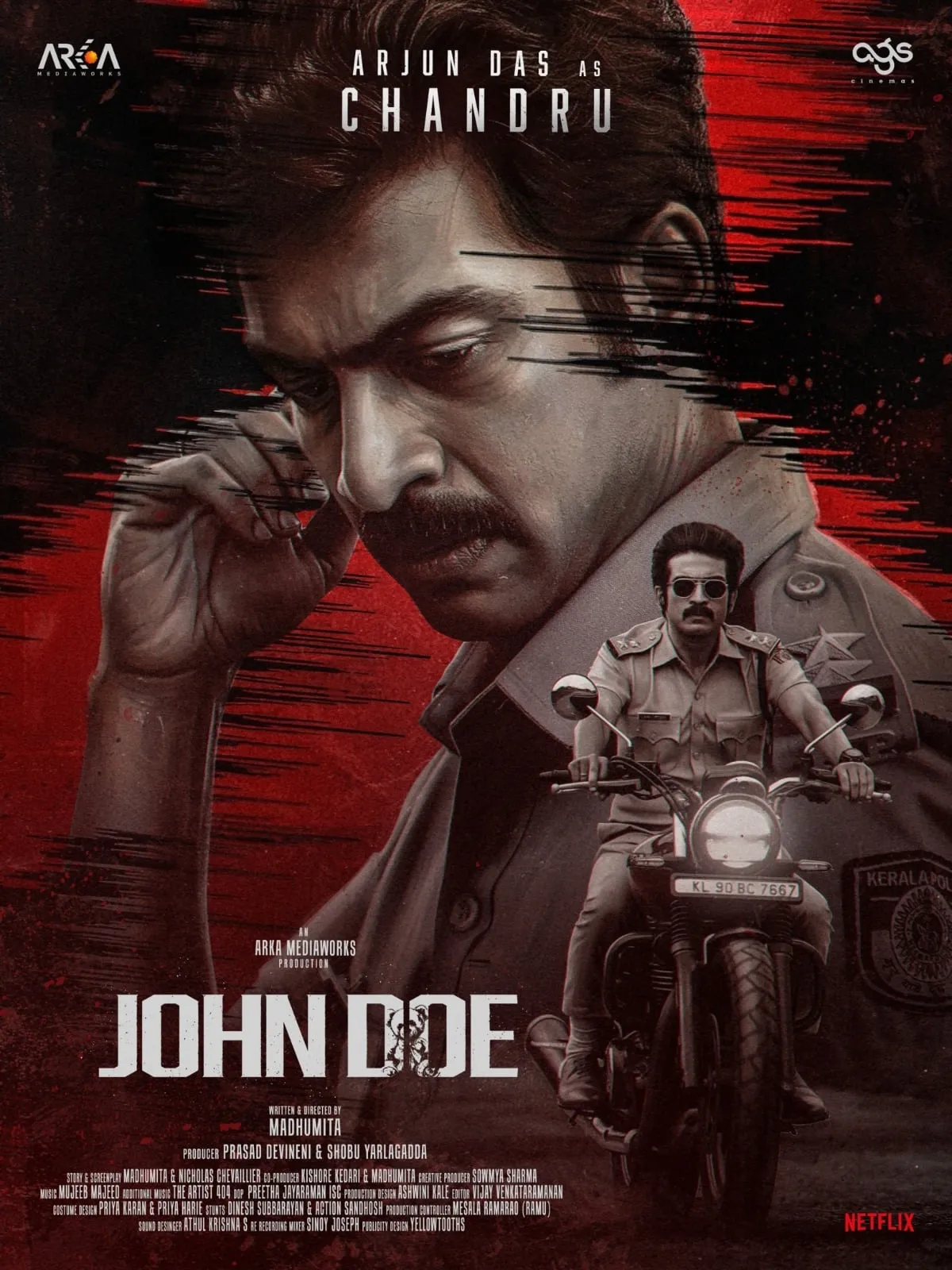 Arjun Das as police officer Chandru in the red-and-black John Doe first-look poster, with a motorcycle image below his close-up