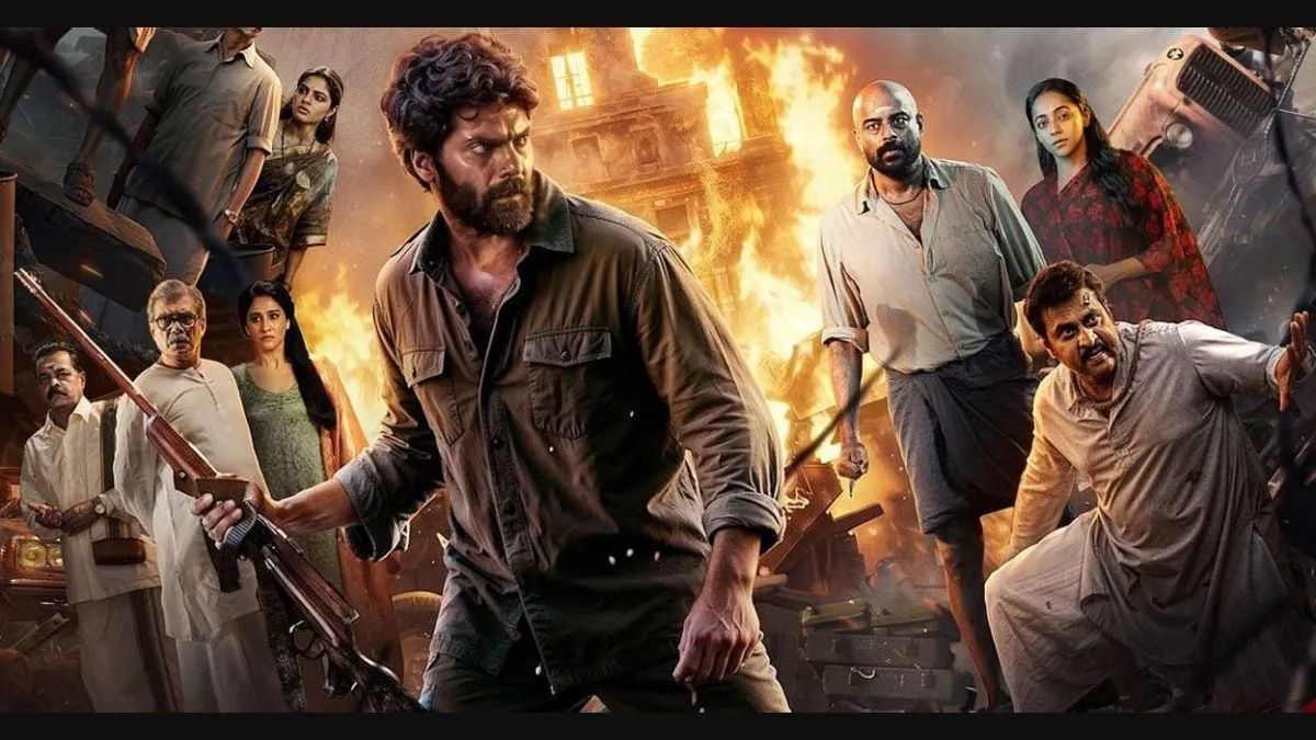 Arya as Vetrivel Kumaran holding a rifle, fronting an ensemble of weathered characters against a burning period cityscape in Ananthan Kaadu
