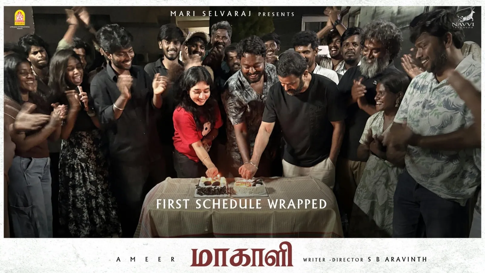 The Maakaali cast and crew gather around a table to cut a cake marking the end of the first schedule