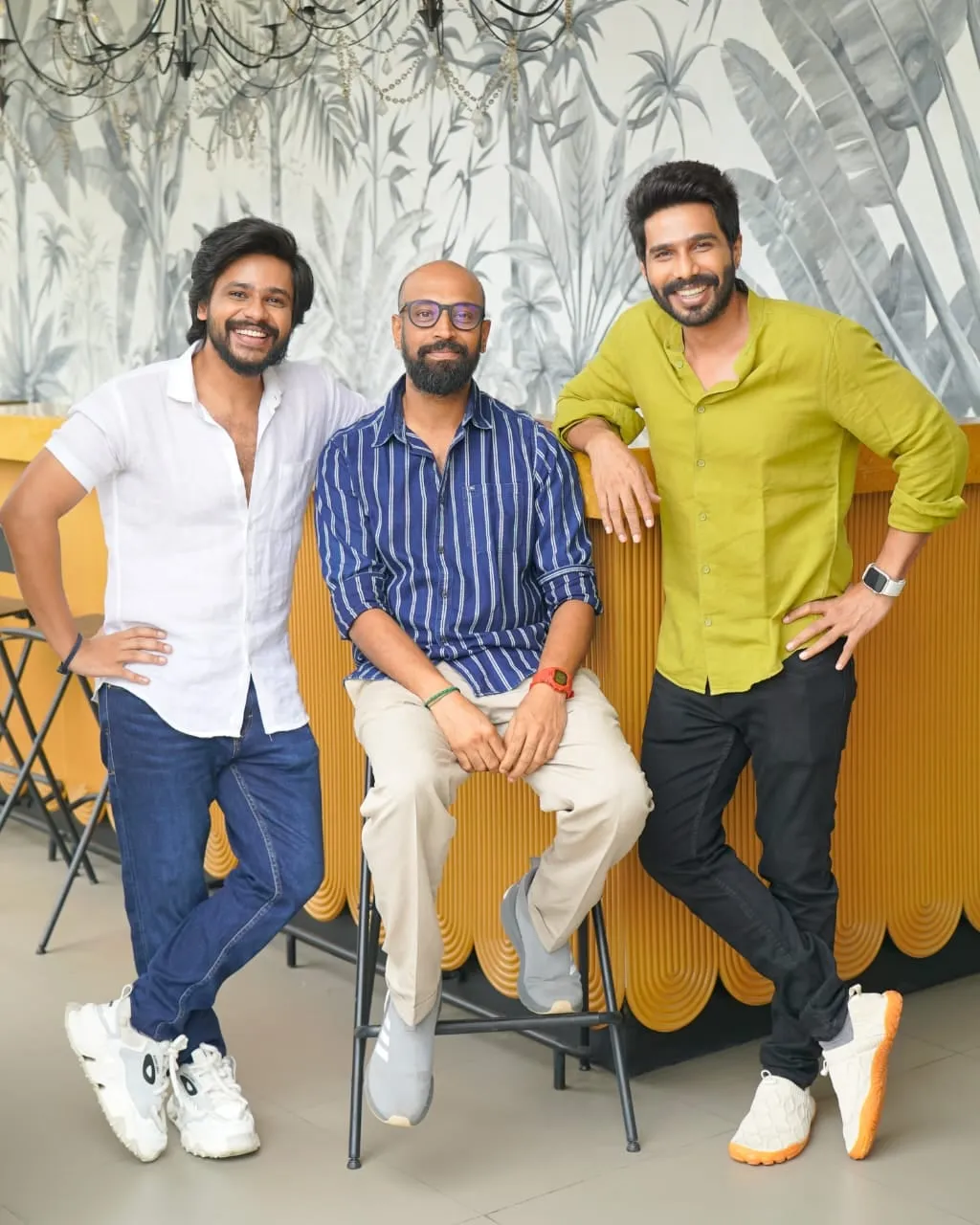 Vishnu Vishal at a recent press meet, smiling beside two collaborators.