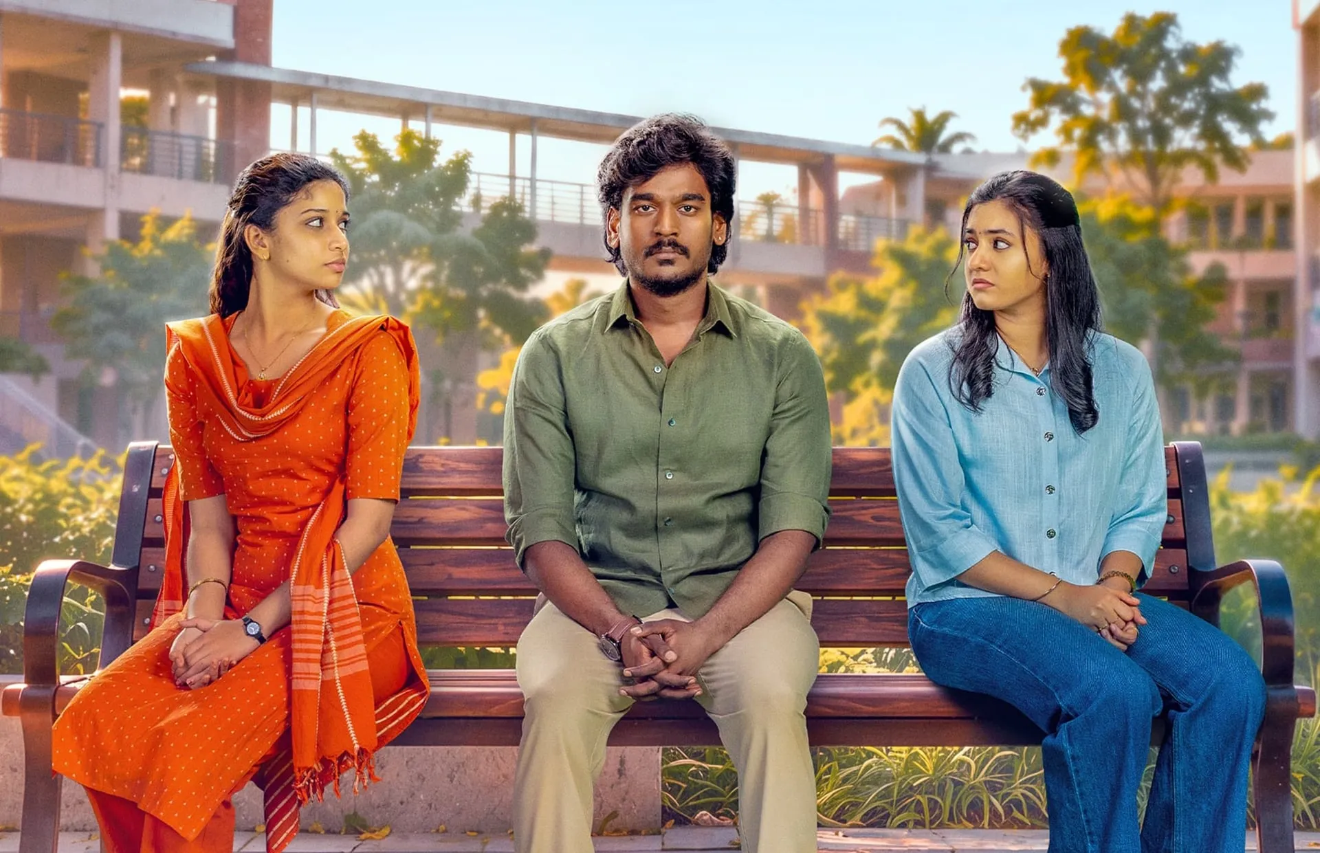 Aegan sits on a campus bench between his two Haiku co-stars, who both turn to look at him