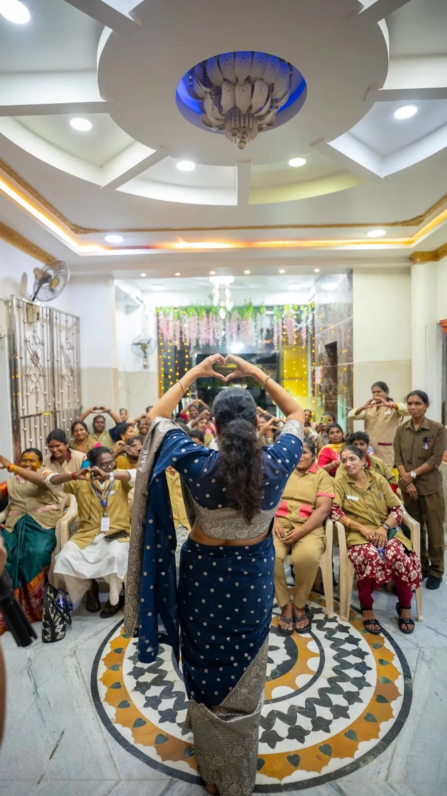 Anumol greets the women drivers seated in the hall.