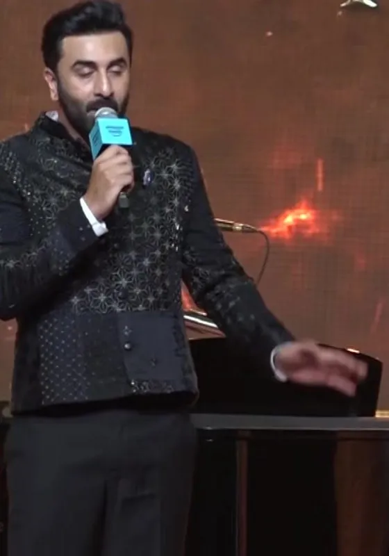 Ranbir Kapoor speaks on stage in a black embroidered jacket at the Ramayana event in Chennai