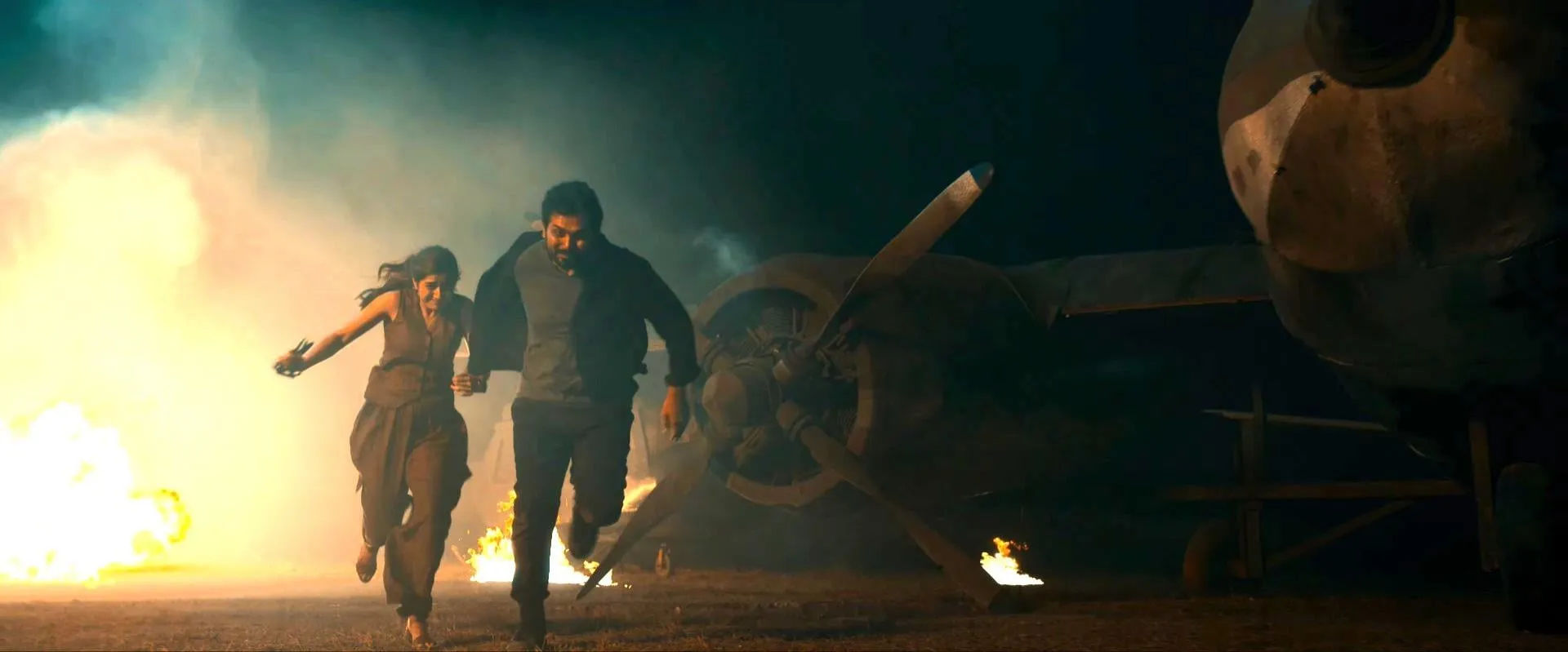 An escape past a burning aircraft is among the sequel's large-scale action sequences.