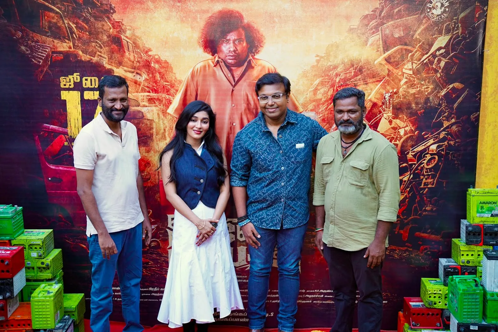 Composer D Imman, in the checked shirt, with the team at the Arjunan Per Paththu launch.
