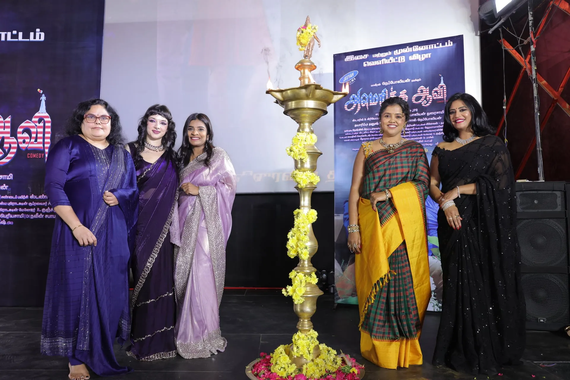Women light the ceremonial lamp at the America Aavi launch